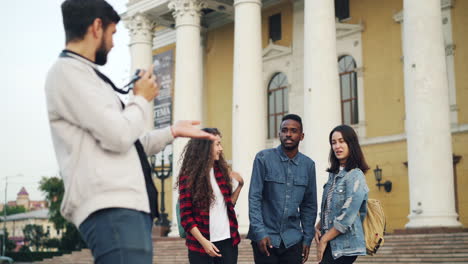 friends posing for a photo in front of a building