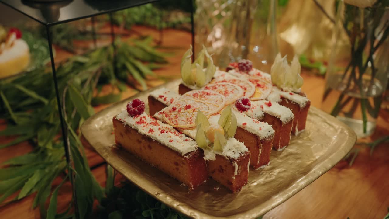 plated lemon desserts with raspberry and fruit garnish on golden tray