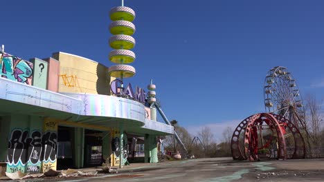 An-abandoned-and-graffiti-covered-game-arcade-at-an-amusement-park-presents-a-spooky-and-haunted-image