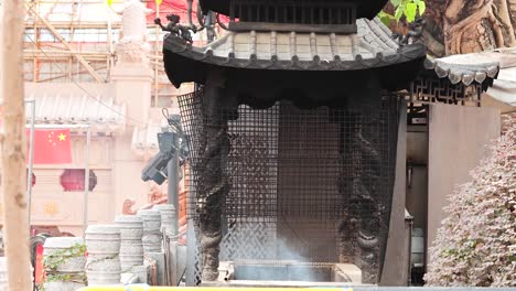 incense smoke wafts through temple structure