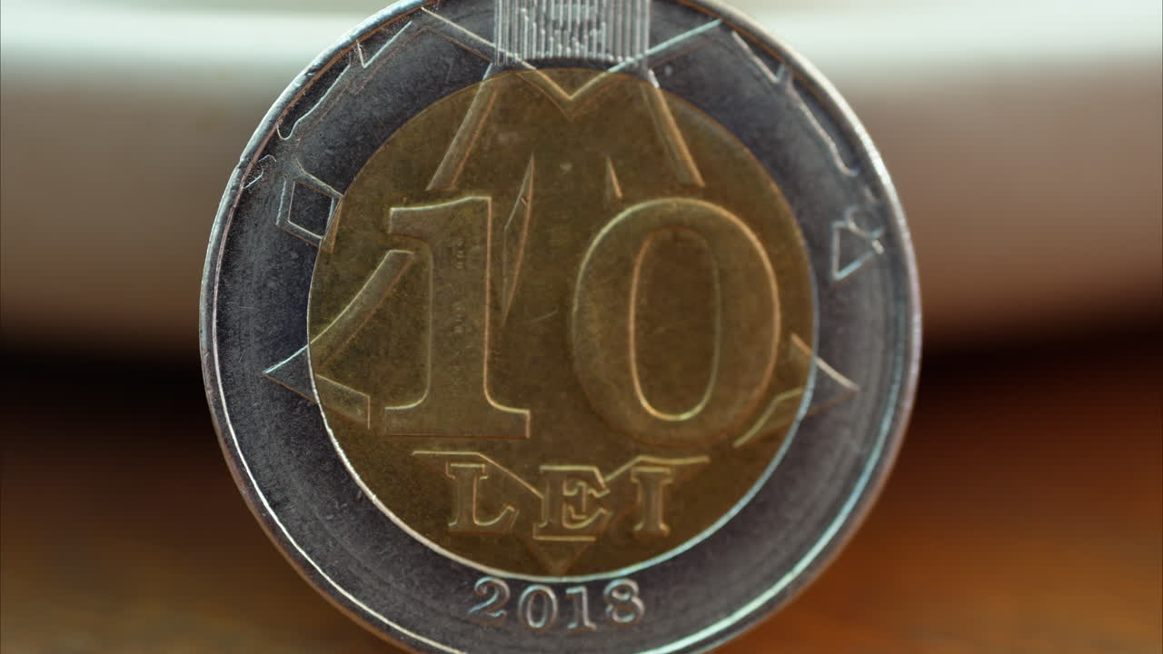Close up of a 10 lei mdl coin on a wooden surface