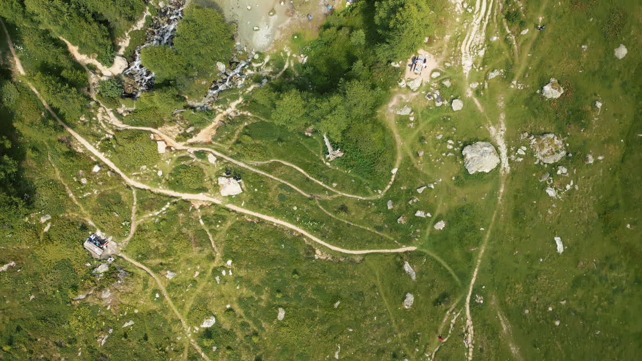 Aerial: Arolla's Blue Lake during the day in Val d'Herens, canton of Valais, Switzerland, top down drone shot