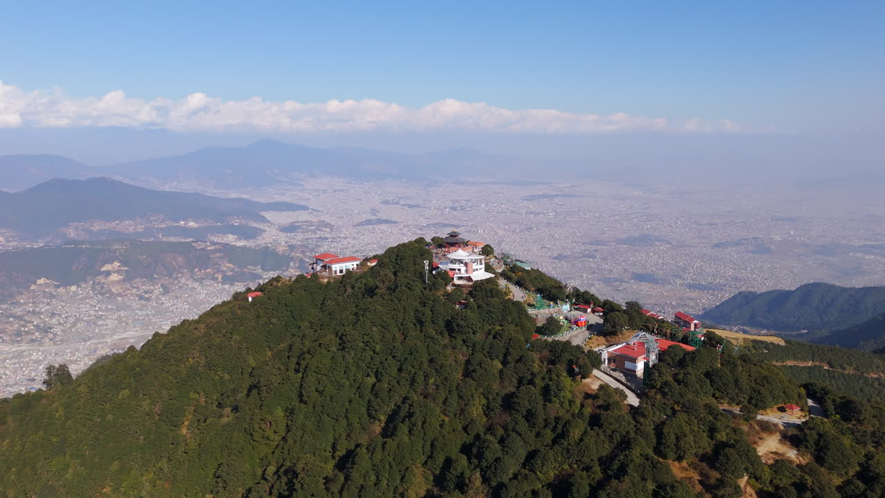 Panoramic drone shot orbiting the Chandragiri hill, in sunny Kathmandu, Nepal
