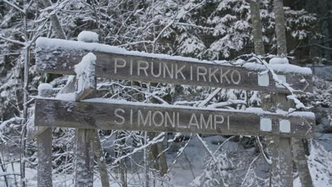 pirunkirkko and simonlampi signs in winter forest in finland