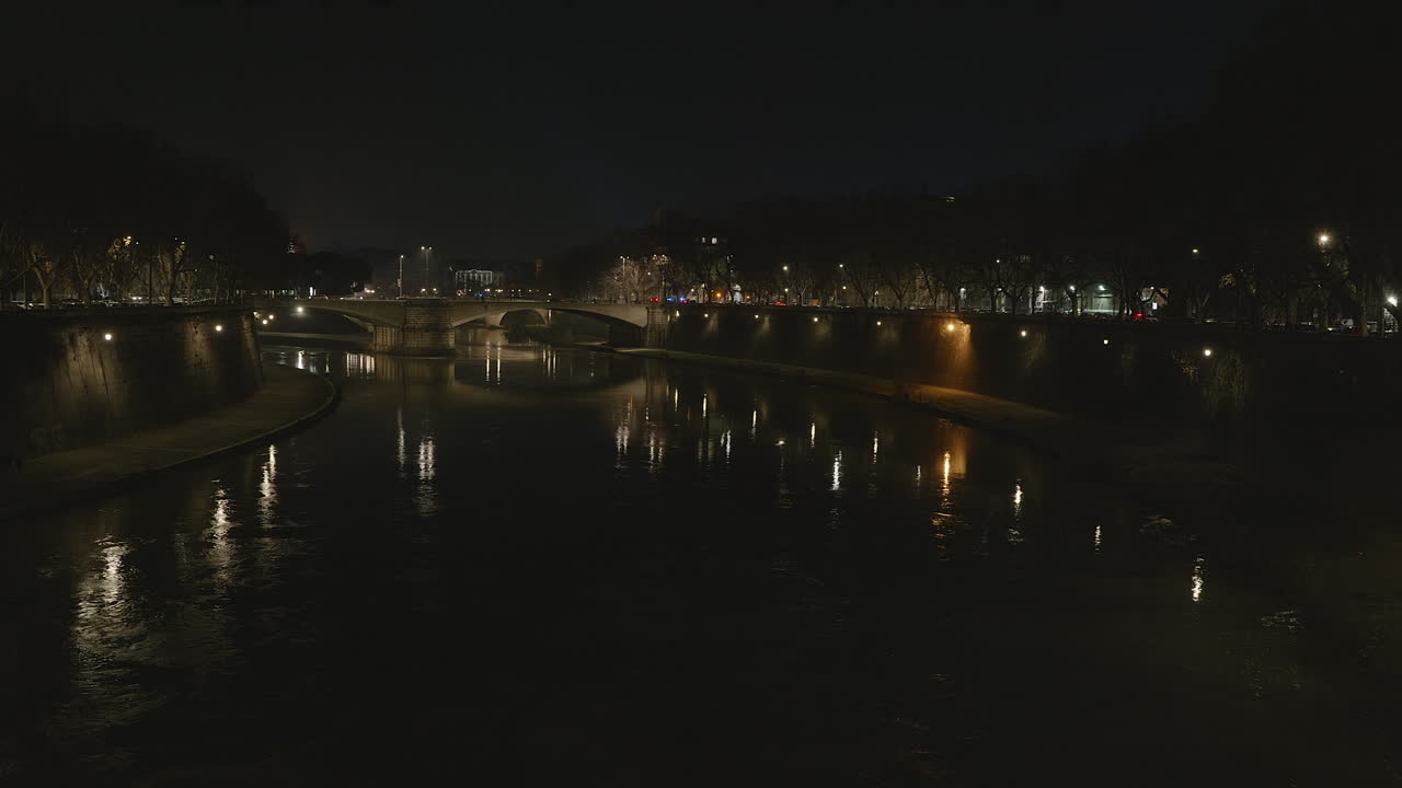 Night time view of a bridge over the river Tiber,  Rome Italy
