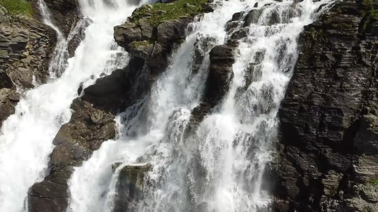 close up of an amazing waterfall in the mountains in switzerland (with a drone)