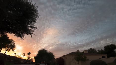 Time-Lapse,-of-clouds-spreading-across-the-sky-like-flowing-water-at-sunset