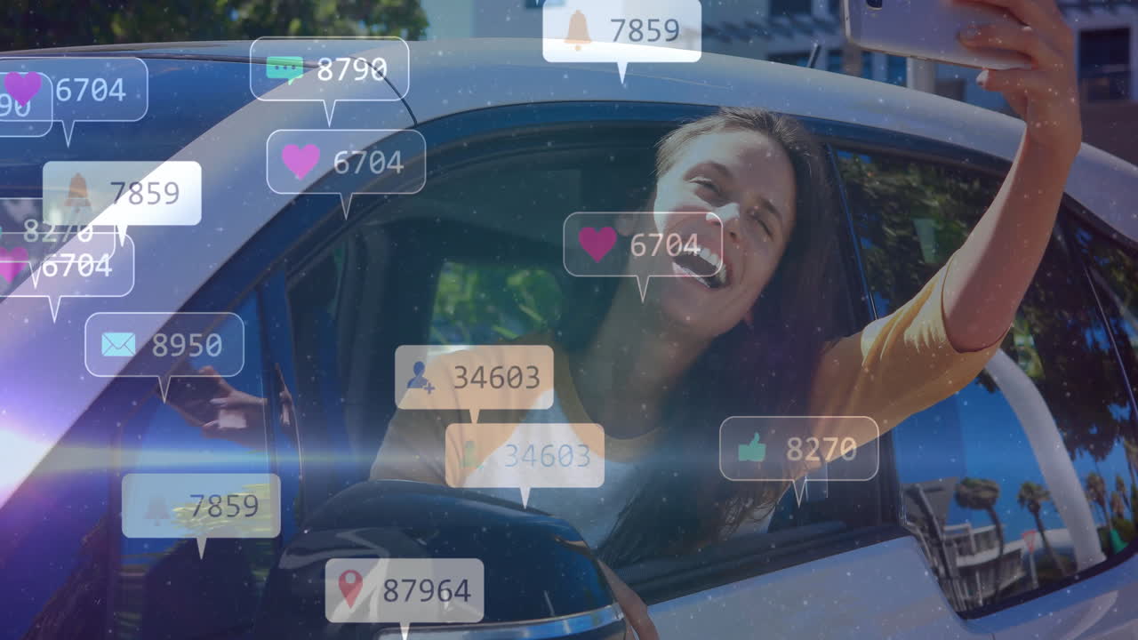 Taking selfie in car, woman seeing animation of social media notifications