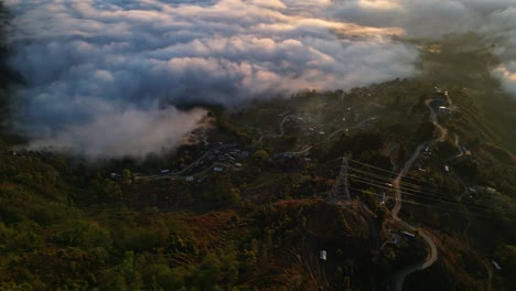 sea of clouds shine red and white from sunrise along lush green valley ridge