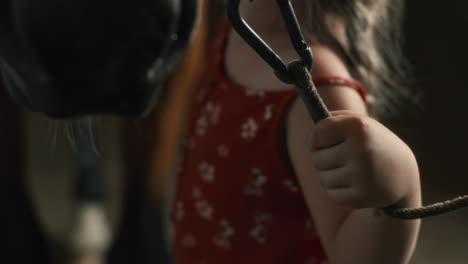 little girl holding horse rope