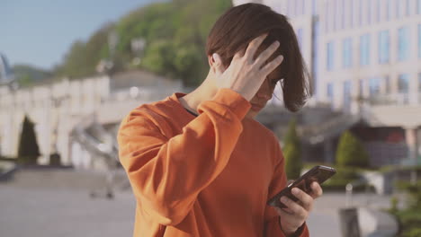 teenager sending a message with his cellphone