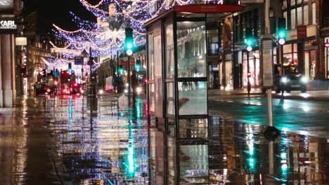 winchester city center during a rainy and dark night with multiple cars driving through the shot