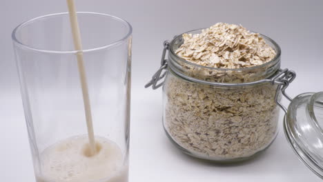 Close-Up-Slow-Motion-Pouring-A-Glass-Of-Oat-Milk