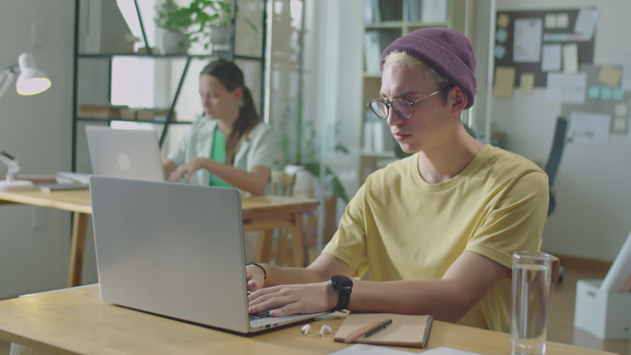 Gen Z Man Working on Laptop in Office