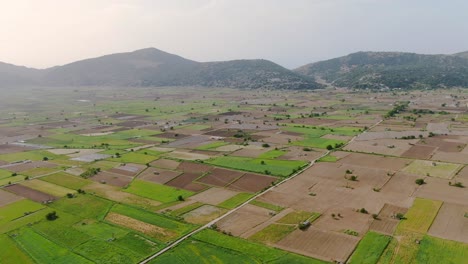 drone shot of agriculture farm fields in lastihi, crete, greece