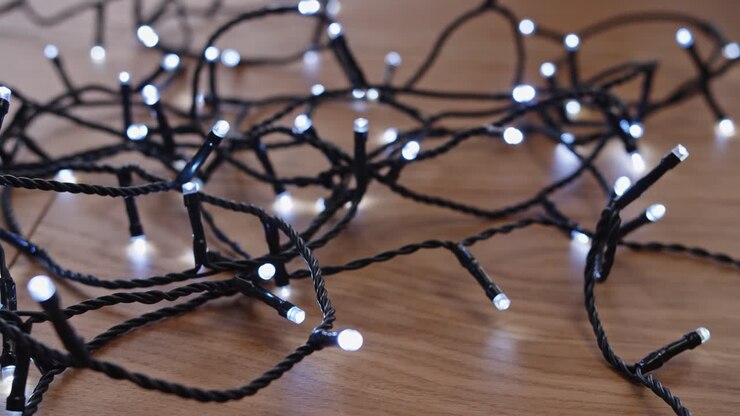 Testing LED Christmas Tree Light on Wooden Floor Close Up 4K