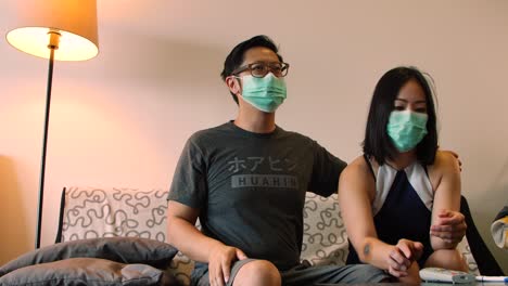 asian couple get into fight about social distancing on couch