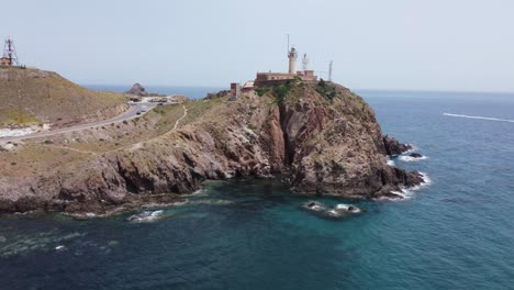 flying around a lighthouse standing on a cliff