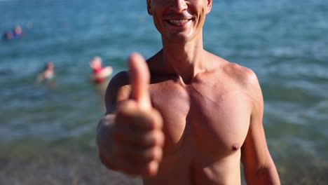 man on the beach giving a thumbs up