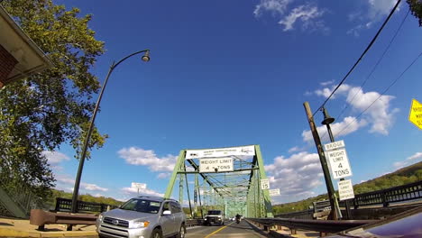 time-lapsed shot driving onto and across steel truss bridge