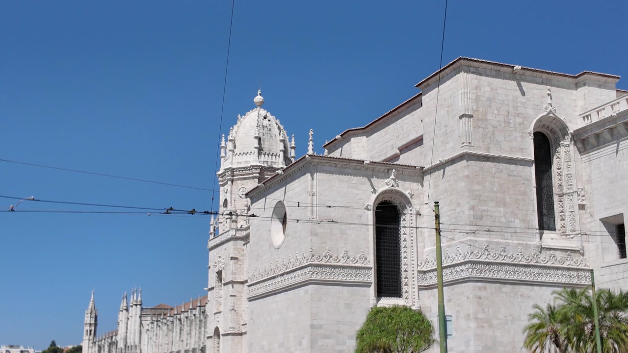 Jeronimos Monastery in Lisbon, Portugal, displaying its stunning Manueline architecture under a clear blue sky