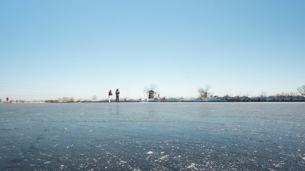 Beautiful time lapse of ice skaters on frozen canal in Netherlands winter