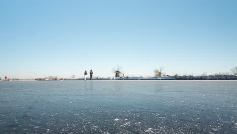 beautiful time lapse of ice skaters on frozen canal in netherlands winter