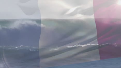 Digital-composition-of-france-flag-waving-against-aerial-view-of-waves-in-the-sea