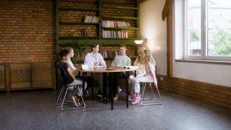 Young-teacher-talking-with-the-students-at-class