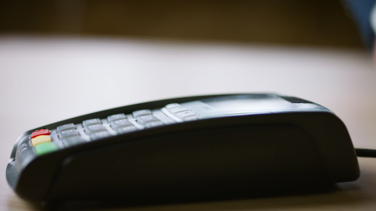 Contactless credit card payment on bank terminal close up. Hand paying with NFC.