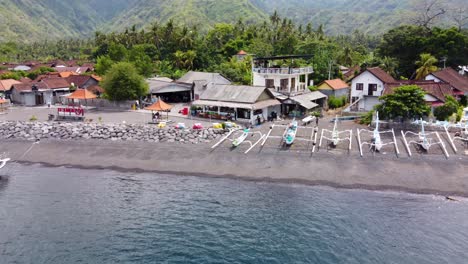 Tropical-ambience-of-Amed-village-beachfront-in-Bali---Indonesia,-Aerial