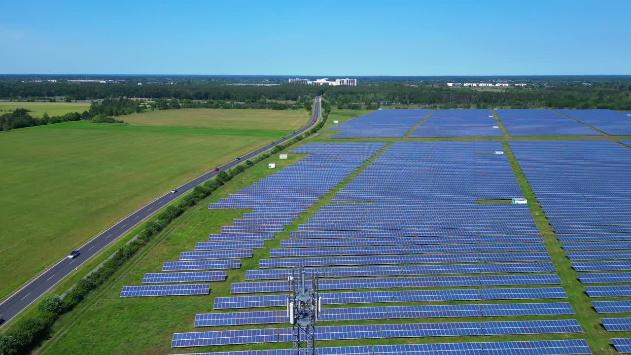 5g Telecommunication tower in a huge solar panel plant in Germany, capturing the convergence of technology and sustainability. Gorgeous aerial view flight drone shot footage from above