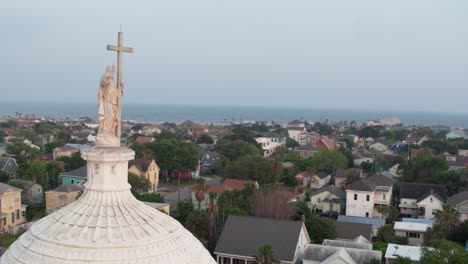 Drone-view-of-Statue-on-top-of-the-Sacred-Heart-Catholic-Church-in-Galveston,-Texas