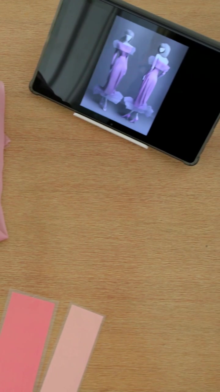Vertical video: Moving cam showing phone with purple dresses and swatches for matching, copy space