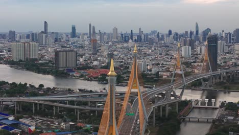 close-up of bhumibol bridge with bangkok cityscape in background