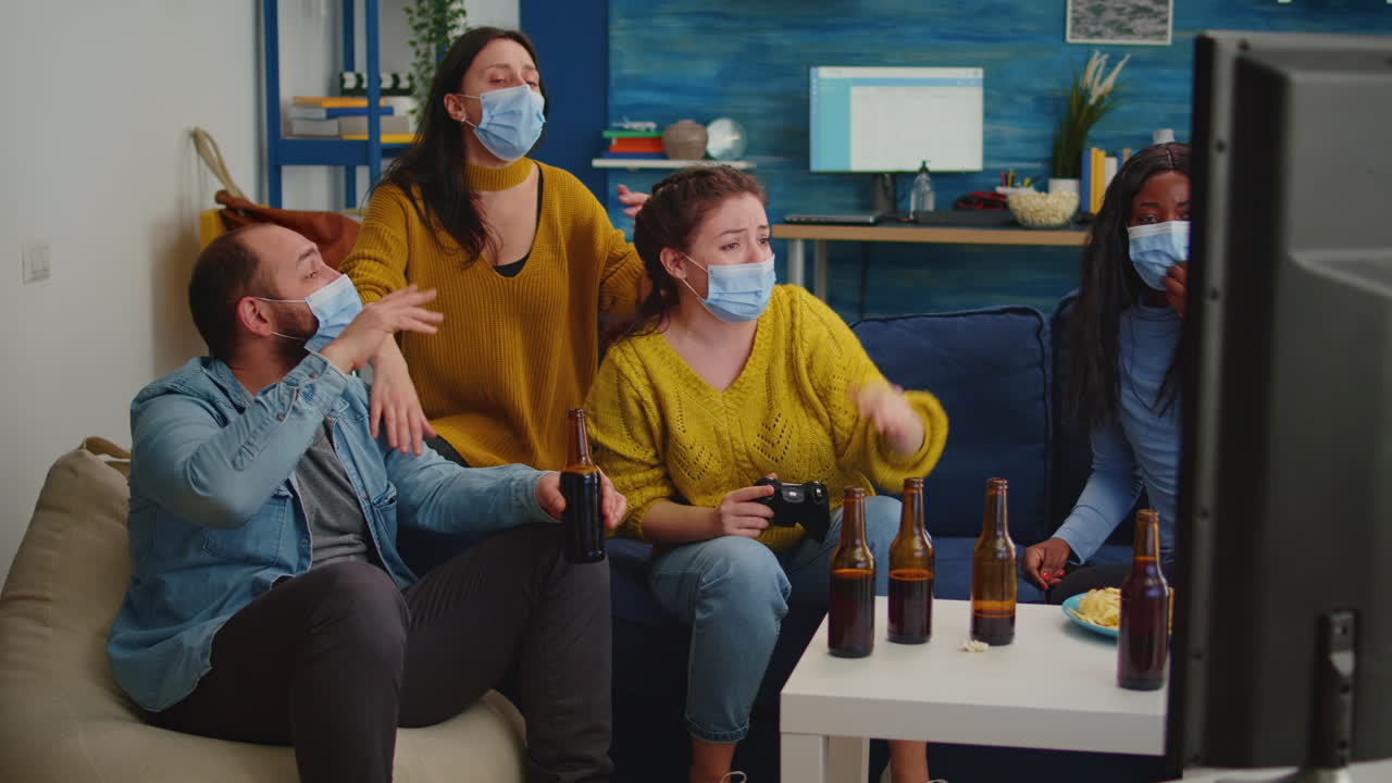 Disappointed diverse people loosing playing video games at home