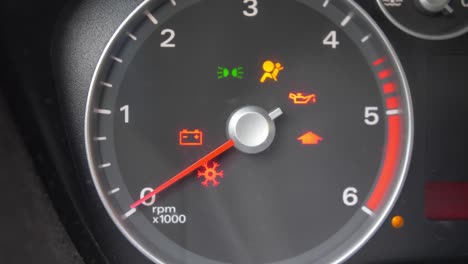 tachometer gauge of starting and stopping car close up