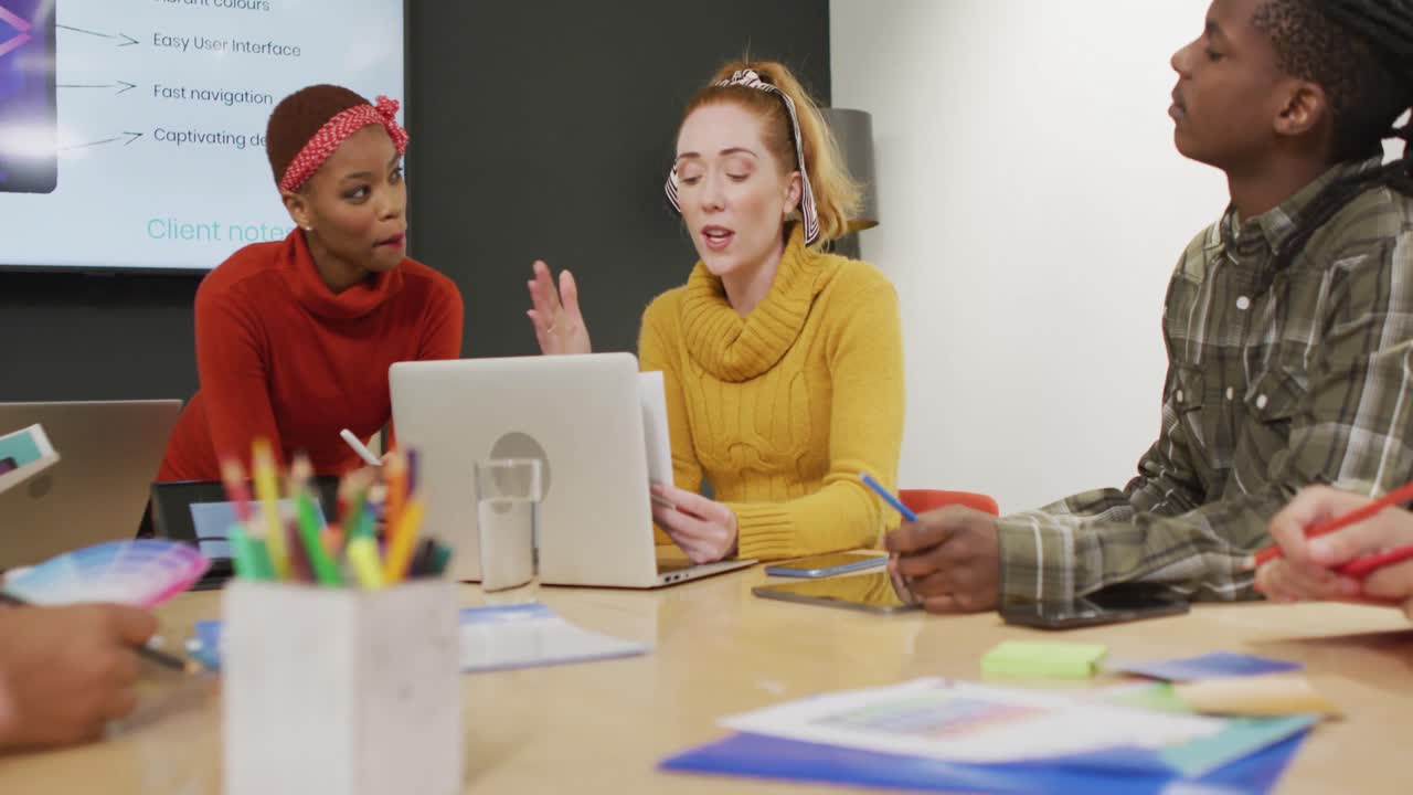 Happy diverse business people discussing work during meeting at office