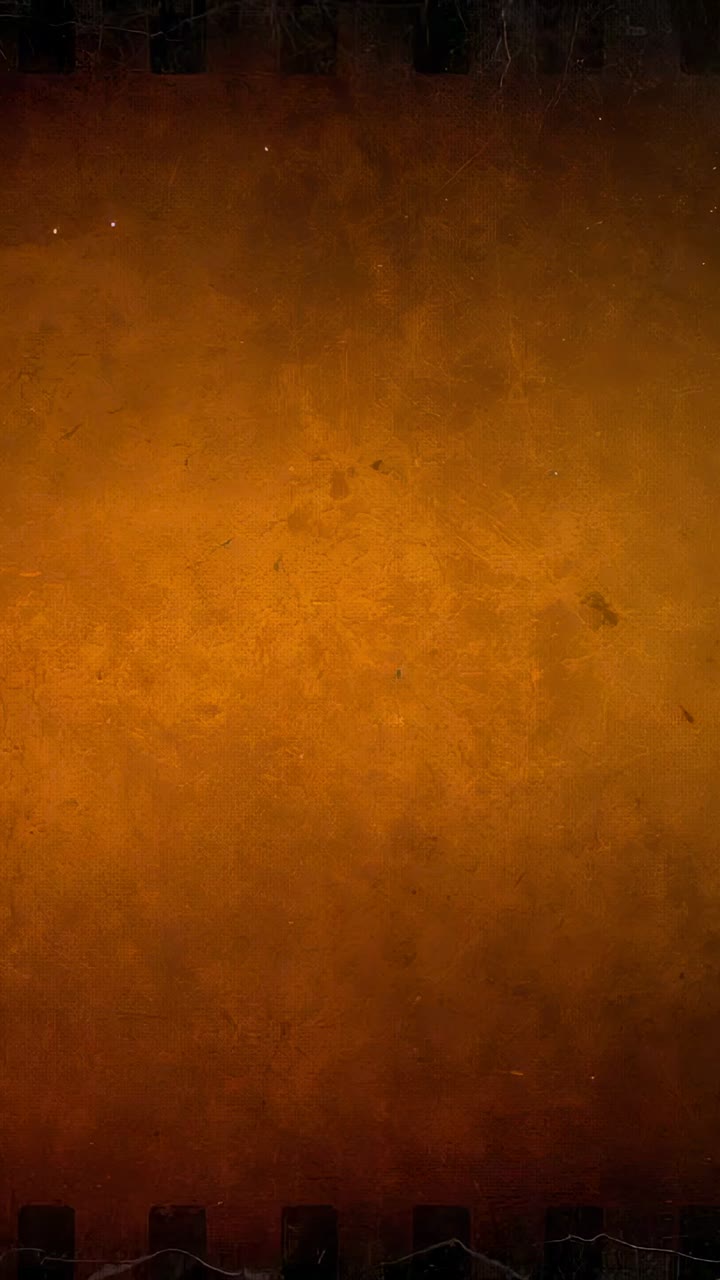 Vertical video: Camera staying fixed, amber backdrop showing scratches and notched strip in studio