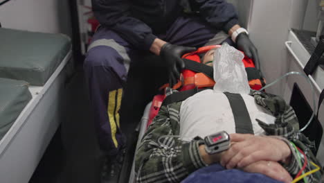 Patient,-paramedic-and-man-with-oxygen-mask