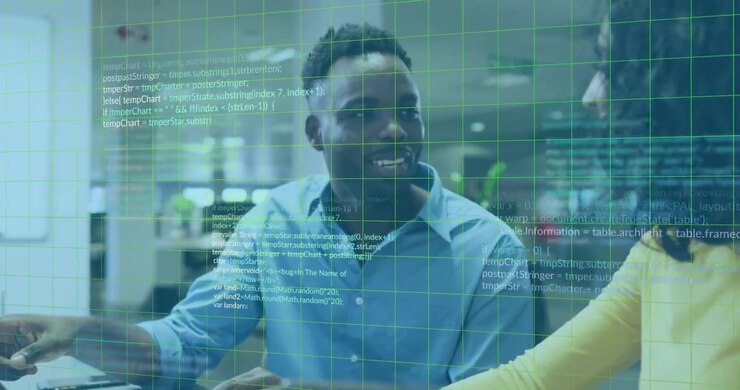 Male coworker pointing at laptop, causing green grid and code overlay, coworkers analyzing software