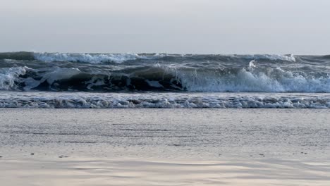 small sea waves breaking on the shore of the beach