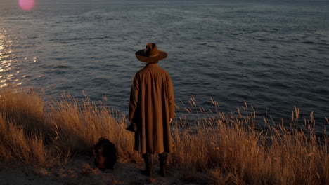 man contemplating sunset by the river
