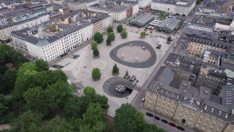 from an aerial perspective, witness the vibrant city life of israels plads in copenhagen at noon, teeming with people and activity