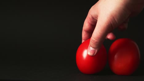 red fresh tomatoes on a black background