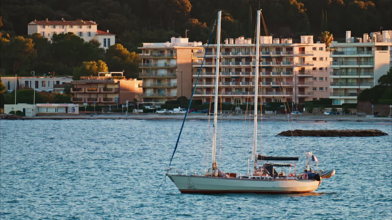 Juan-les-Pins, France - January 25, 2025: Small boat floating on the sea at sunset