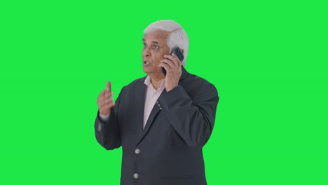 Angry-Indian-senior-manager-shouting-on-someone-over-call-Green-screen