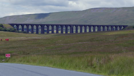 wide shot of the whole ribblehead viaduct with road in foreground