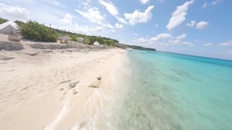 FPV-speed-flight-over-beautiful-clear-Caribbean-Sea-Water,-sandy-beach-and-coastline-of-Cabo-Rojo,Dominican-Republic