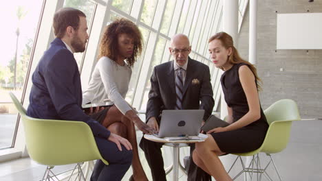 business meeting with laptop in office foyer shot on r3d